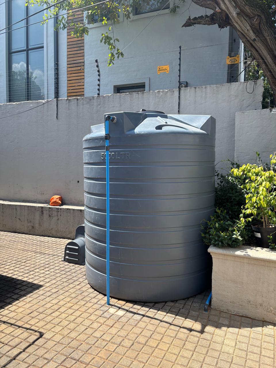 Municipal water backup system with storage tanks and booster pump