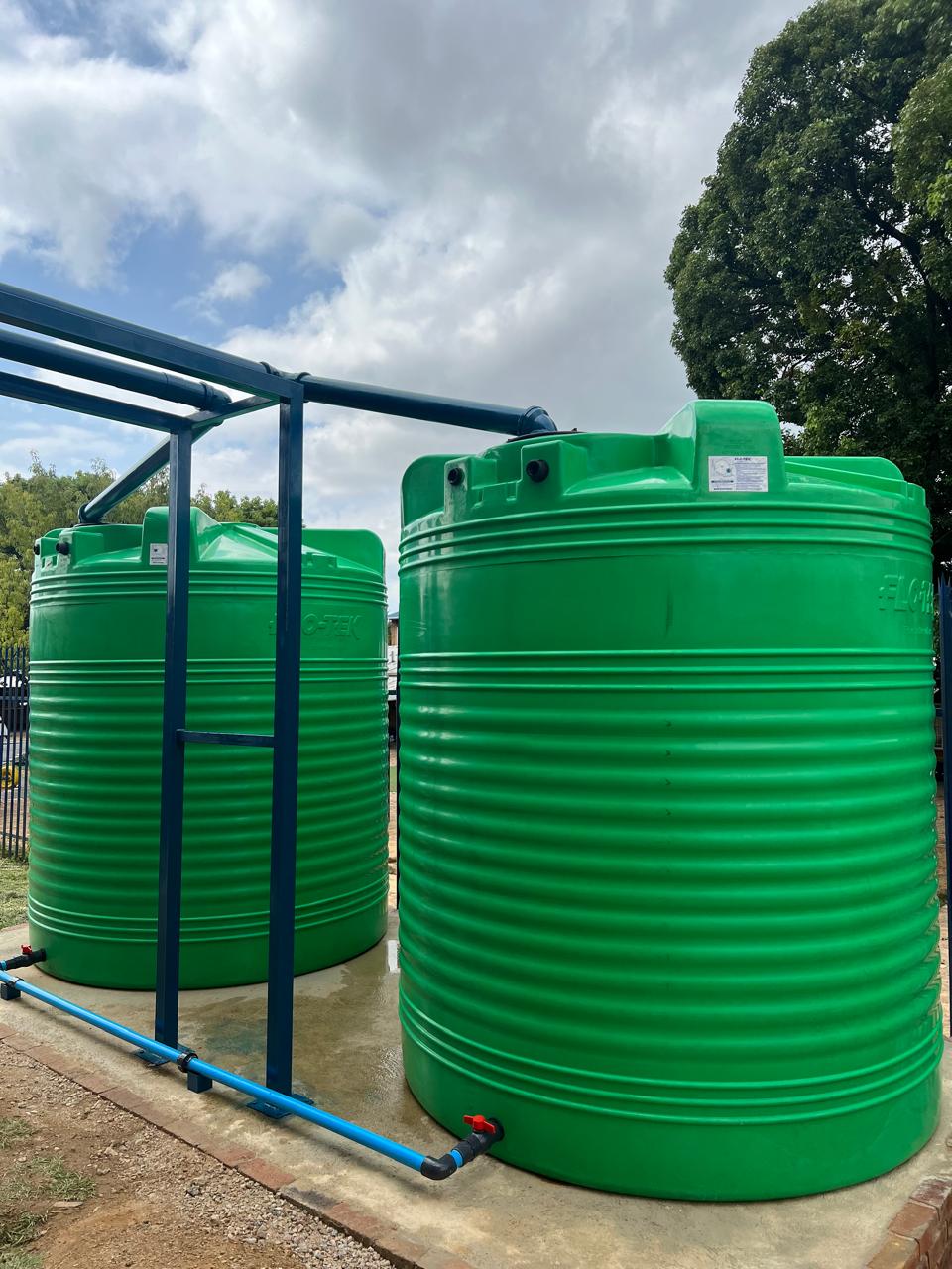 Green JoJo water storage tank on a residential property