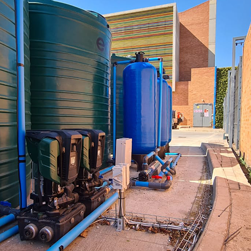 Water pump and tank with green pipes and control system