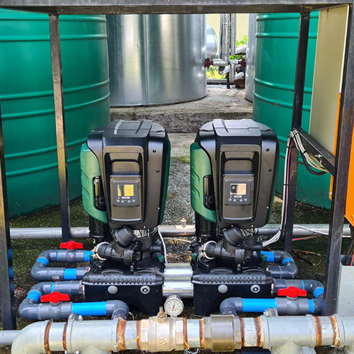 Borehole water pump and tank with green pipework
