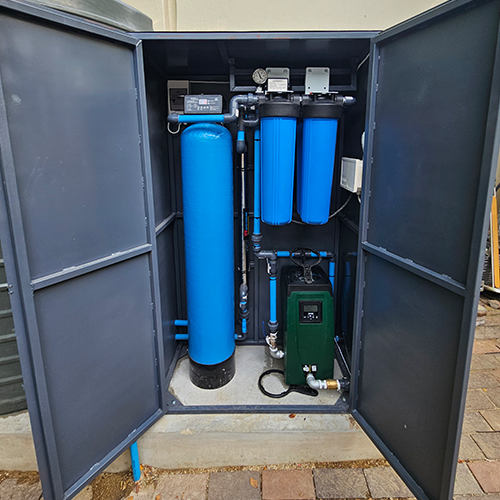 Water tank with pipes and electrical control box