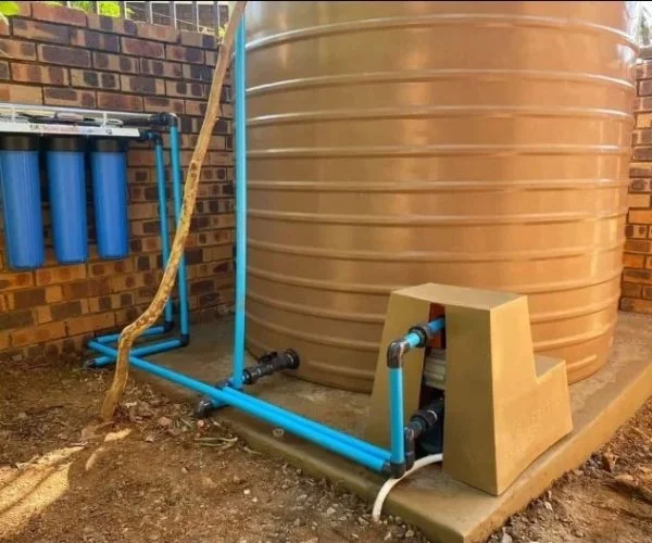Household water backup system with tanks and pump